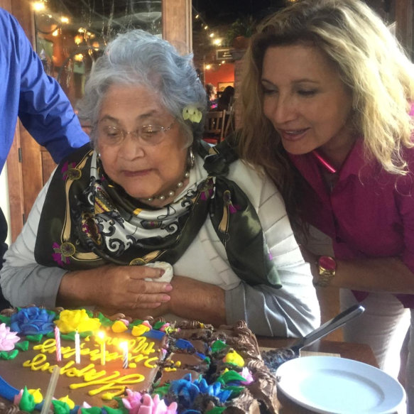Woman walking and embracing elderly woman